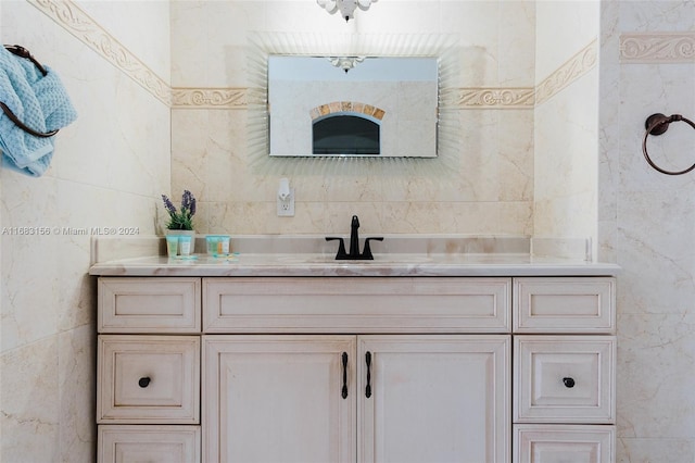 bathroom featuring vanity and tile walls