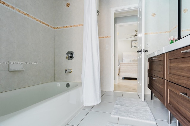 bathroom with vanity, shower / bath combination with curtain, tile walls, and tile patterned flooring