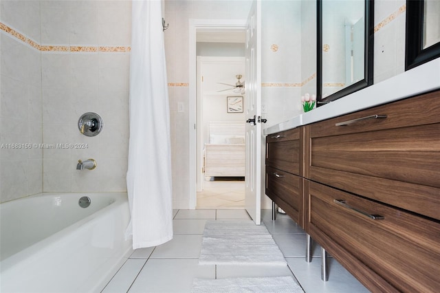 bathroom with tile patterned floors, shower / bath combo, vanity, tile walls, and ceiling fan