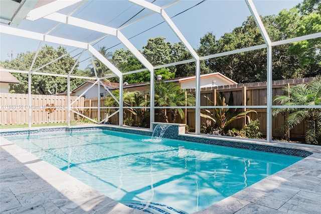 view of pool featuring pool water feature and glass enclosure