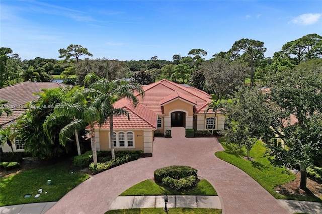 mediterranean / spanish home featuring a front yard