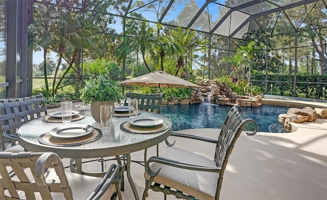 view of swimming pool featuring a patio, pool water feature, glass enclosure, and a jacuzzi