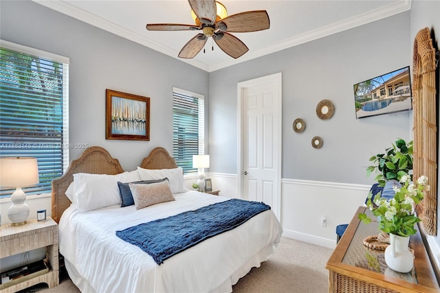 bedroom with light carpet, multiple windows, ornamental molding, and ceiling fan