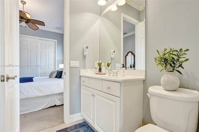 bathroom with vanity, ceiling fan, toilet, crown molding, and tile patterned floors