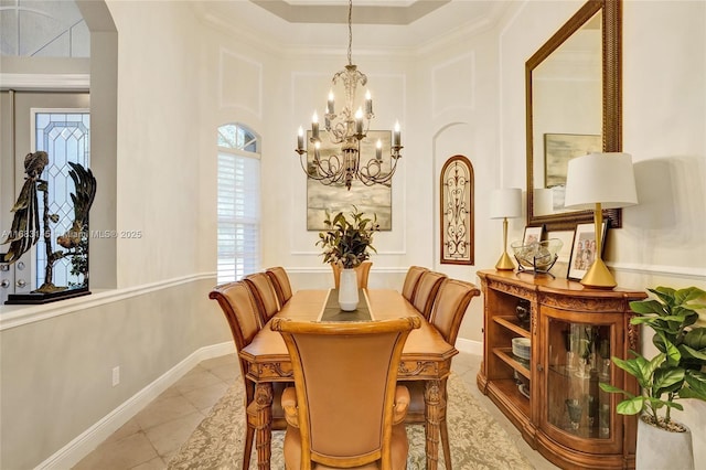 dining room with light tile patterned floors, crown molding, and a chandelier