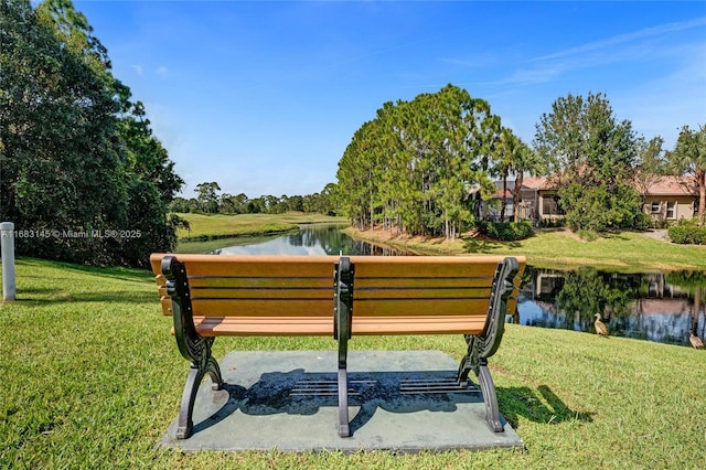 view of community with a water view and a yard