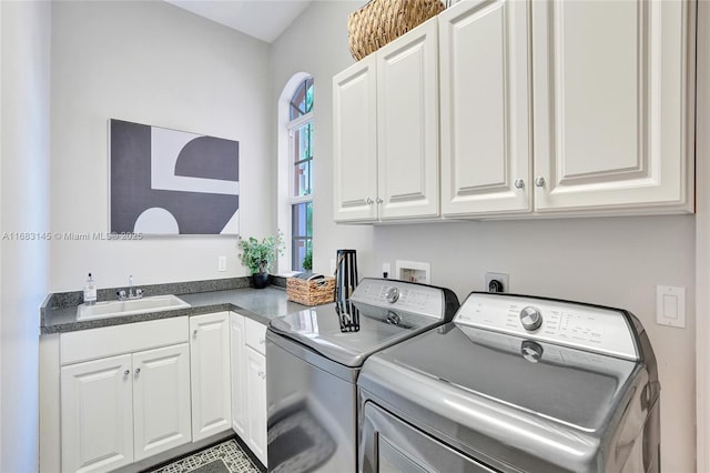 washroom featuring separate washer and dryer, sink, and cabinets