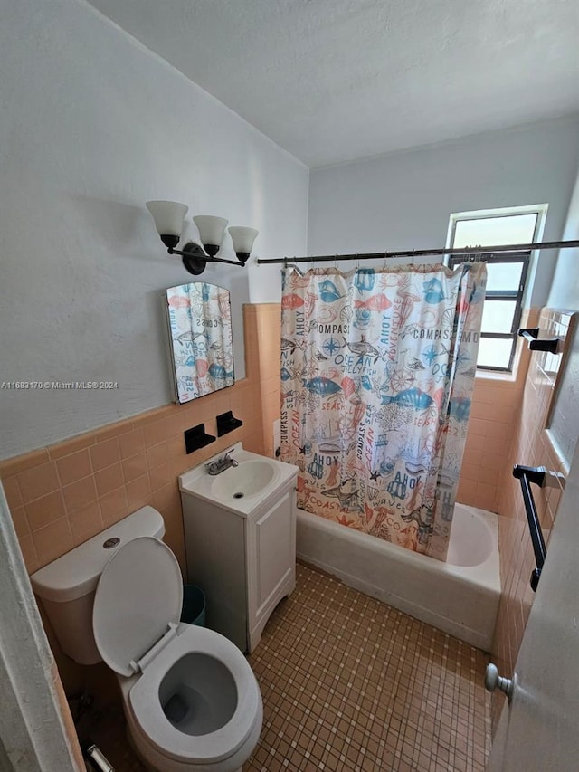 full bathroom with shower / bath combo, toilet, vanity, tile walls, and a chandelier