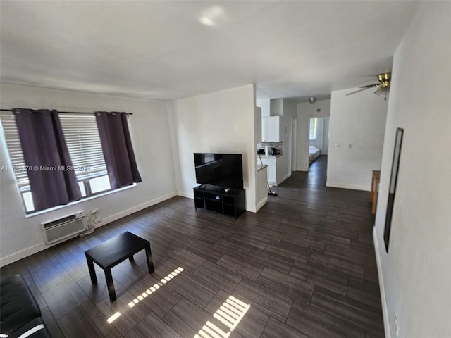 living room with ceiling fan, dark hardwood / wood-style floors, and a wall unit AC