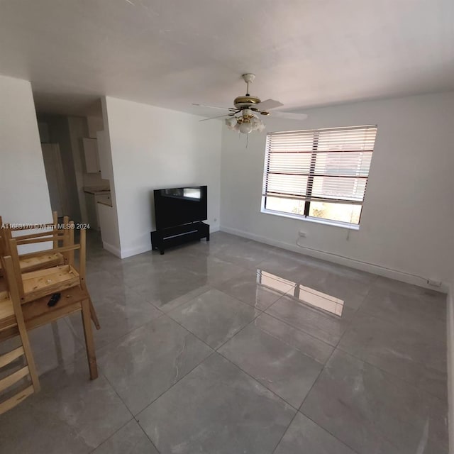 unfurnished living room with ceiling fan