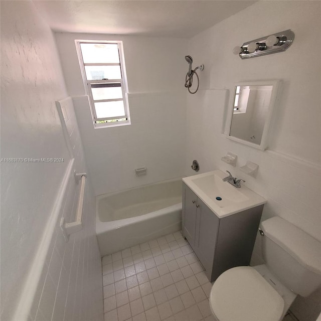 full bathroom with toilet, tile patterned flooring, tub / shower combination, vanity, and tile walls