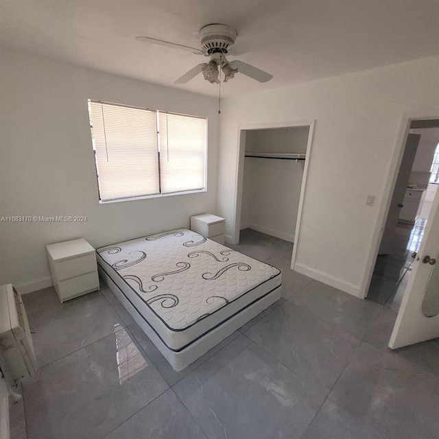 unfurnished bedroom featuring a closet, washer / clothes dryer, and ceiling fan