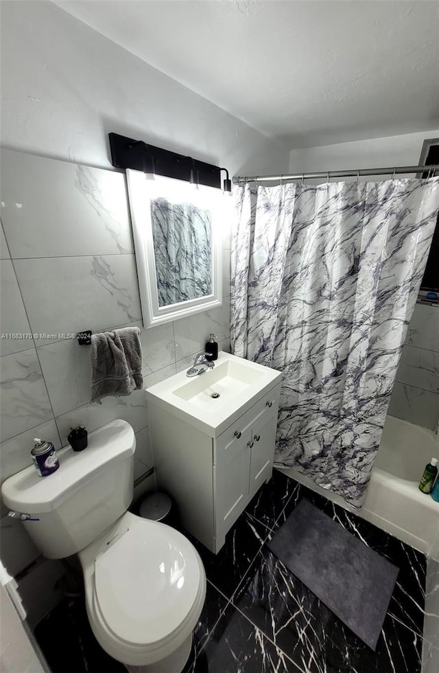 full bathroom with vanity, toilet, tile walls, and shower / tub combo with curtain