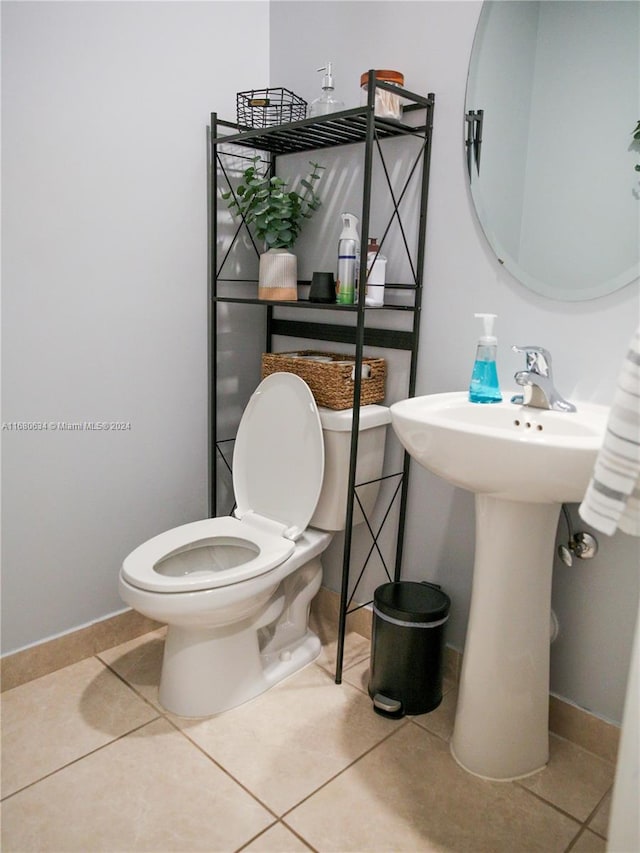 bathroom with toilet and tile patterned flooring