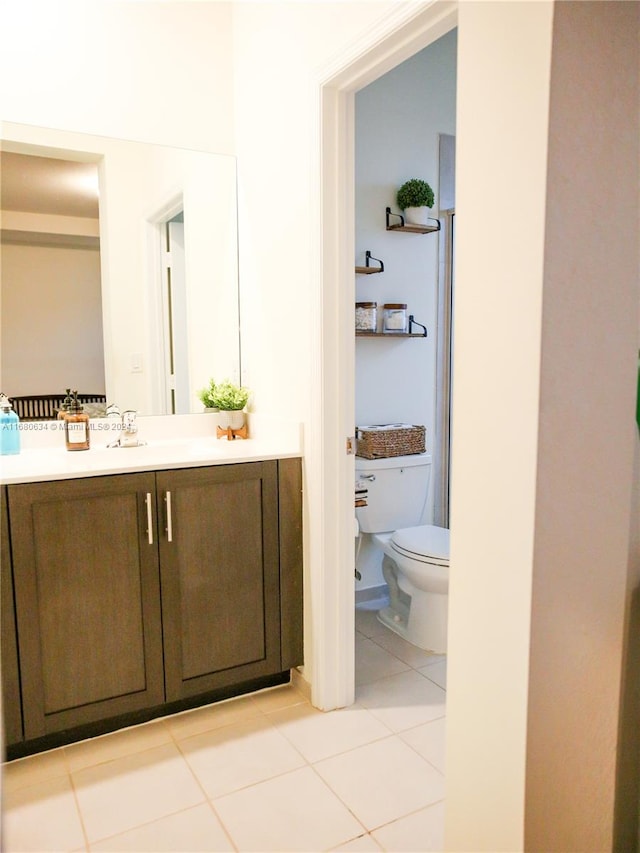 bathroom with vanity, toilet, and tile patterned floors