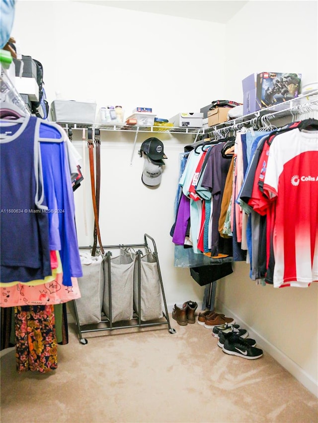 walk in closet with carpet floors