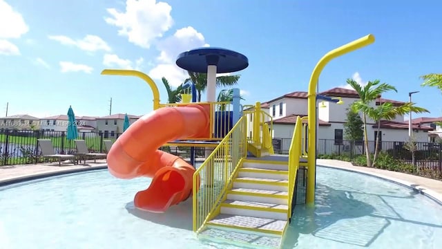 view of playground with a community pool