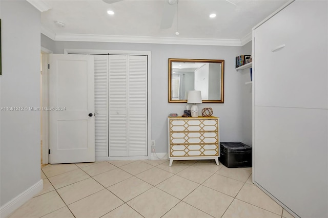 interior space with ornamental molding, light tile patterned floors, and ceiling fan