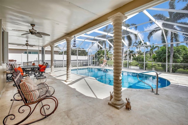 view of swimming pool with a patio, ceiling fan, and a lanai