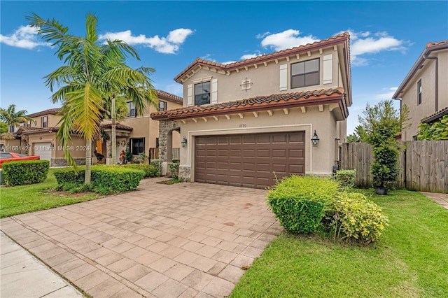 mediterranean / spanish home with a garage