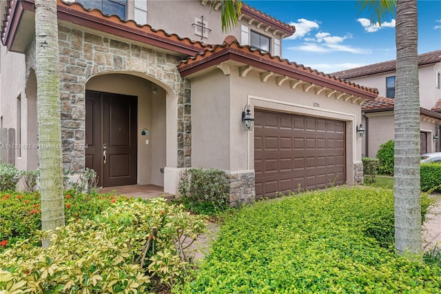 view of exterior entry with a garage