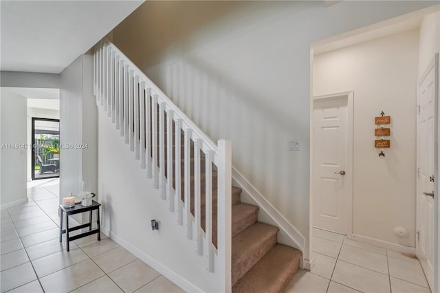 stairs featuring tile patterned flooring