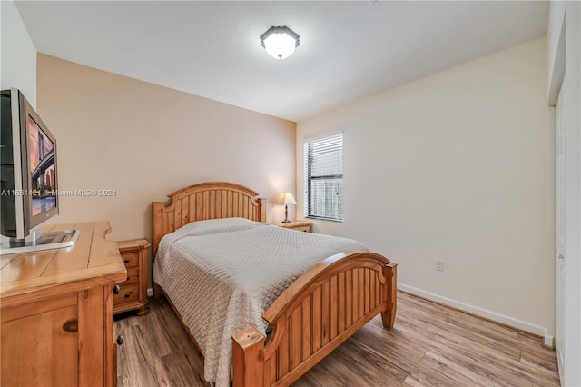 bedroom with hardwood / wood-style floors