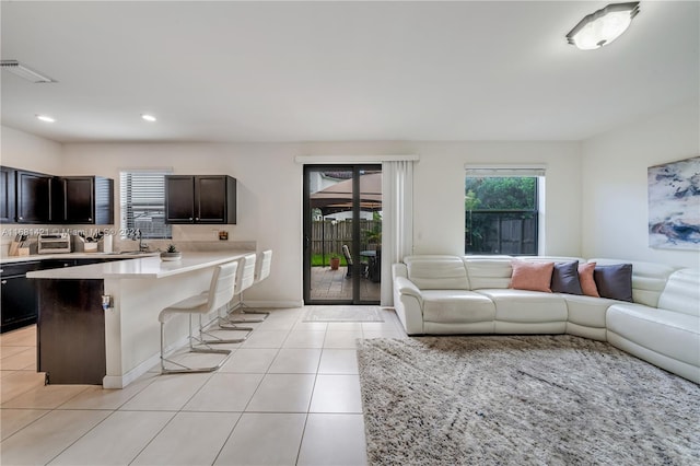 living room with light tile patterned flooring and sink