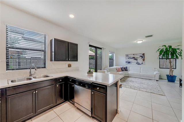 kitchen with sink, dark brown cabinets, stainless steel appliances, and light tile patterned floors