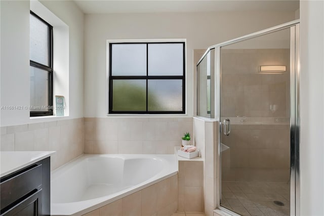 bathroom featuring vanity and plus walk in shower