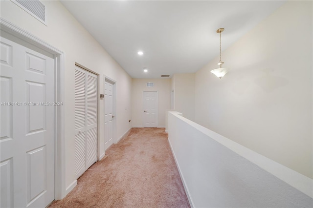 hallway with light colored carpet