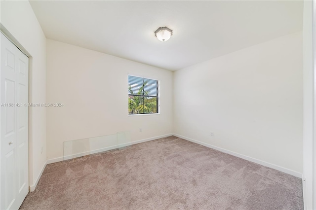 unfurnished room with light carpet