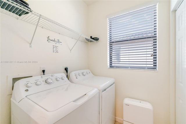 clothes washing area featuring separate washer and dryer