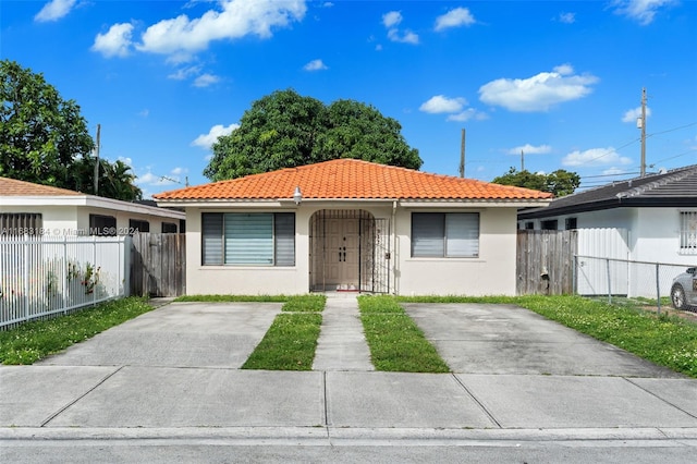 811 W 33rd St, Hialeah, FL 33012 - bungalow-style home with stucco siding and a tiled roof