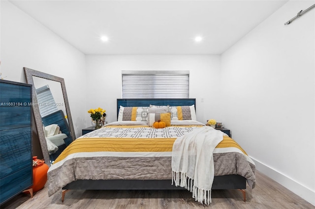 bedroom with hardwood / wood-style flooring