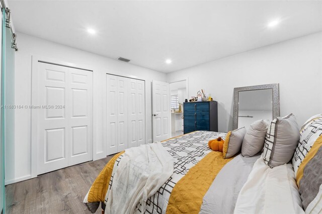 811 W 33rd St, Hialeah, FL 33012 - bedroom featuring two closets, wood finished floors, and recessed lighting