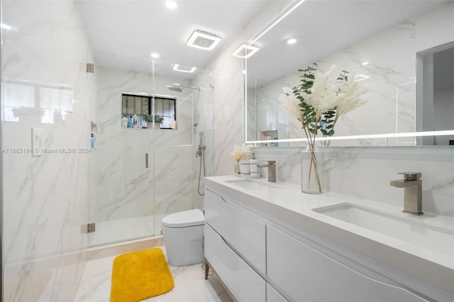 bathroom featuring a shower with shower door, vanity, toilet, and tile walls