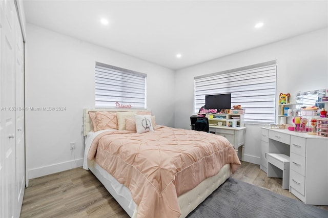 bedroom featuring light wood-type flooring and a closet