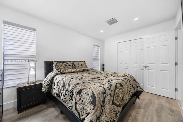 bedroom with hardwood / wood-style flooring and a closet