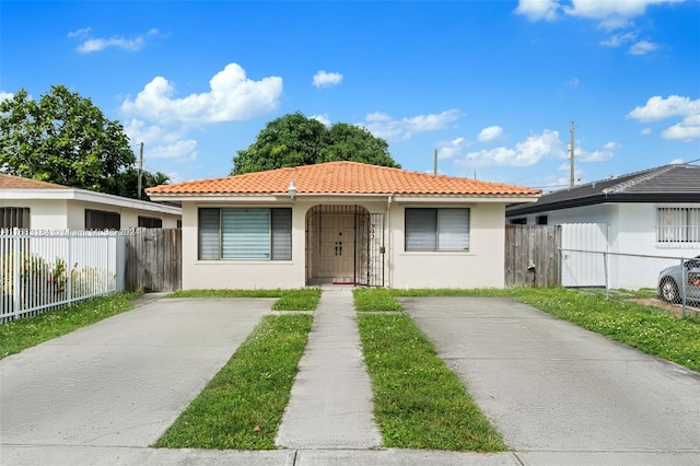 811 W 33rd St, Hialeah, FL 33012 - view of front of property featuring stucco siding and a tiled roof