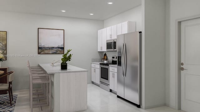 kitchen with appliances with stainless steel finishes, white cabinetry, and a kitchen bar