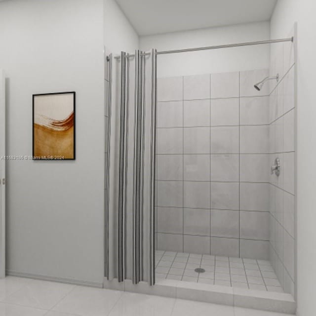 bathroom with tile patterned flooring and tiled shower