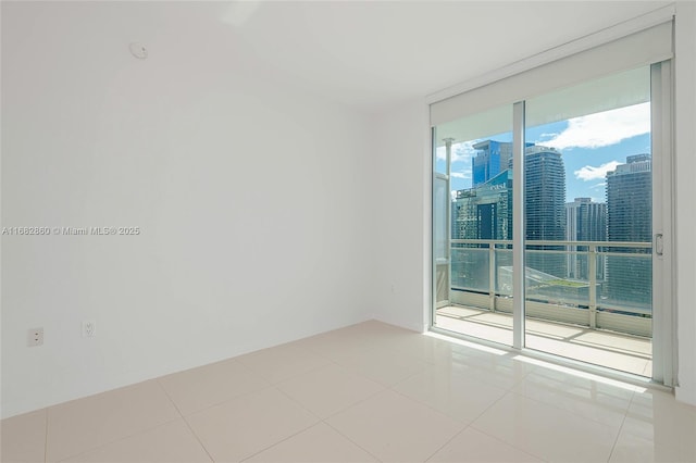 tiled spare room with expansive windows