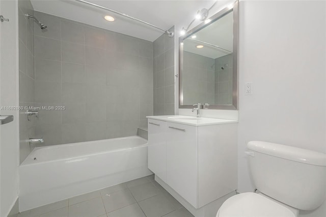 full bathroom with tile patterned flooring, vanity, toilet, and tiled shower / bath