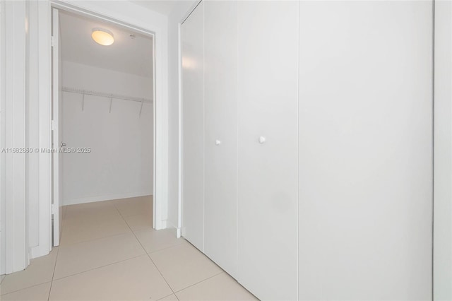 hall featuring light tile patterned floors