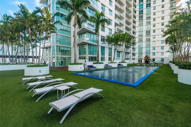 view of property's community featuring a playground and a lawn