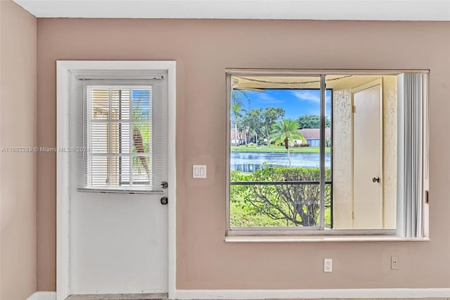 entryway featuring a water view and a wealth of natural light