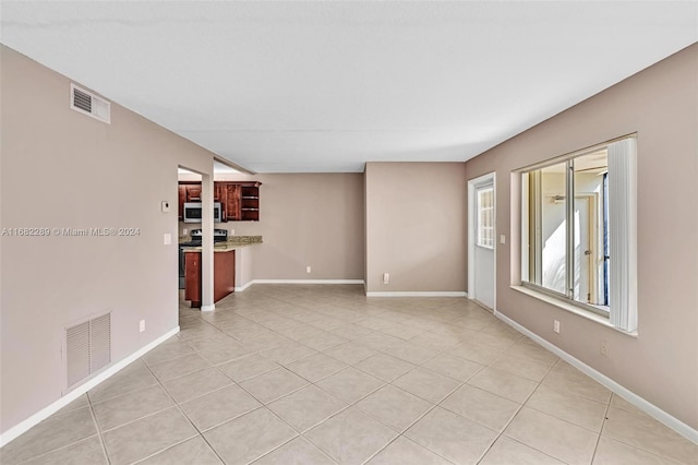 unfurnished room featuring light tile patterned floors