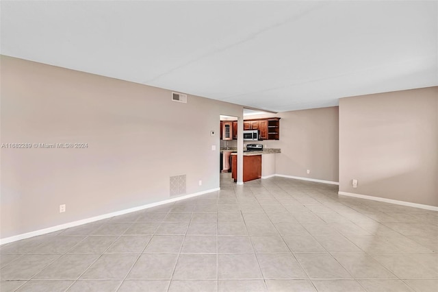 unfurnished living room featuring light tile patterned flooring