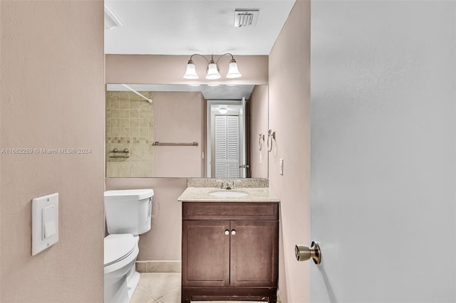 bathroom featuring tile patterned floors, vanity, and toilet